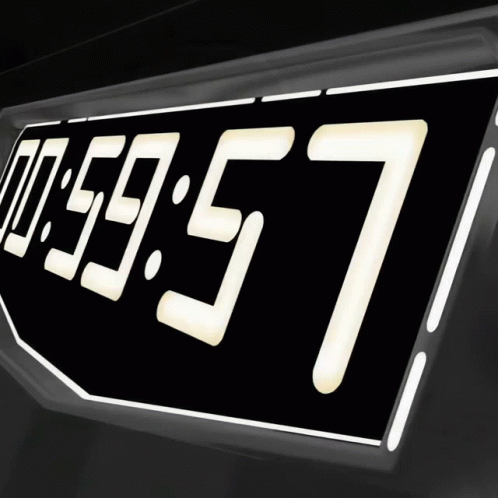 A Digital Clock Reads 00:59:57 On A Black Background GIF