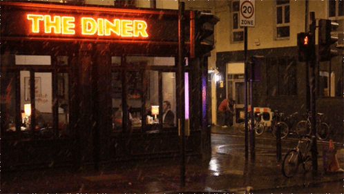 A Diner With A Neon Sign That Says The Diner On It GIF