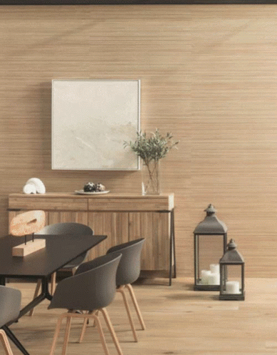 A Dining Room With A Table And Chairs And A Picture On The Wall GIF