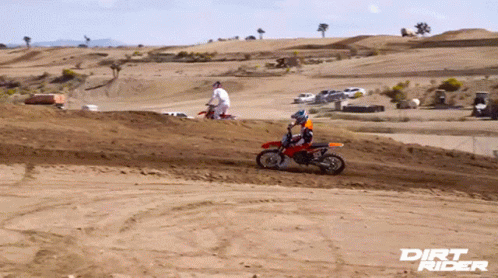 A Dirt Rider Poster Shows A Man Riding A Dirt Bike On A Dirt Track GIF