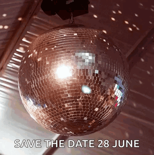 A Disco Ball Is Hanging From The Ceiling With The Words Save The Date 28 June Below It GIF