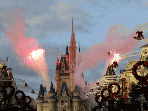 A Disney Castle With Smoke Coming Out Of It And A Sign That Says Disneyland GIF