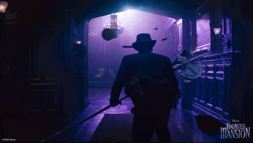 A Disney Haunted Mansion Poster With A Man In A Suit GIF