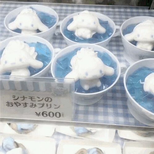 A Display Of Cinnamon Rolls In Cups With A Price Tag Of 600 Yen GIF