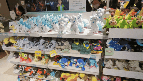 Stuffed Animals Display With Pokemon Sign GIF