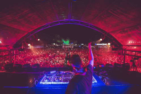 A Dj Playing Music In Front Of A Crowd With A Sign That Says ' X ' On It GIF