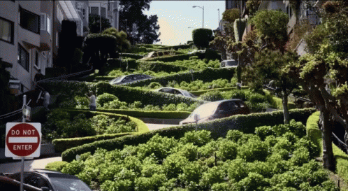 A Do Not Enter Sign Is On The Side Of A Very Narrow Street GIF