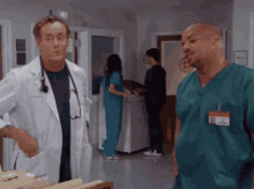A Doctor And A Nurse Are Talking In A Hospital GIF