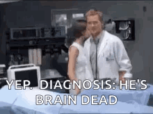 A Doctor And A Woman Are Standing Next To Each Other In A Hospital Room . The Doctor Is Talking To The Woman . GIF