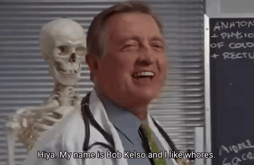 A Doctor Is Standing Next To A Skeleton And Smiling . GIF