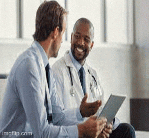 A Doctor Is Talking To A Businessman While Looking At A Tablet . GIF