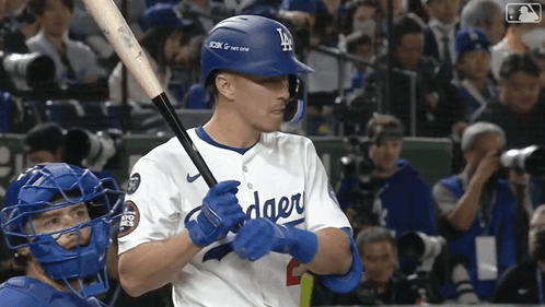 A Dodgers Baseball Player Holds A Bat In His Hands GIF