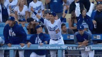 A Dodgers Baseball Player Stands In Front Of A Crowd GIF