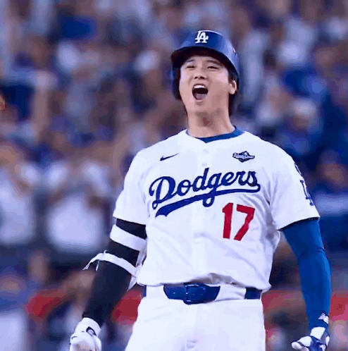 A Dodgers Baseball Player Wearing Number 17 Stands In Front Of The Crowd GIF