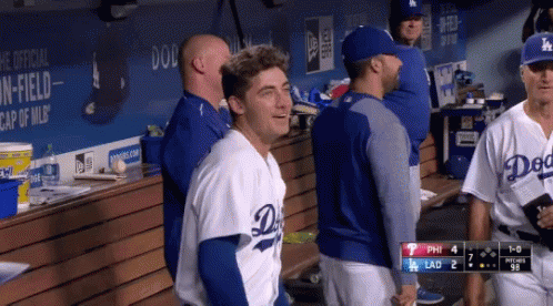 A Dodgers Player Is Standing In The Dugout Talking To Another Player GIF