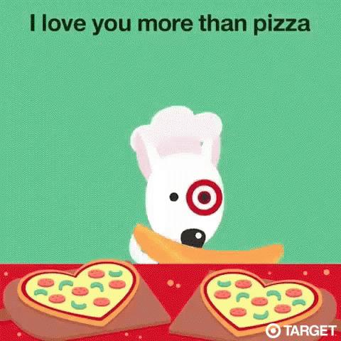 a dog in a chef 's hat is standing next to a table with two pizzas in the shape of hearts .