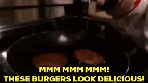 A Dog Is Looking At Burgers In A Frying Pan And Says " Mmmm Mmmm Mmmm " GIF