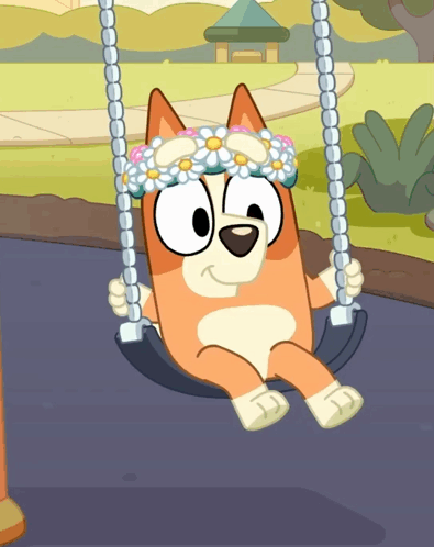 A Dog Wearing A Flower Crown Sits On A Swing GIF