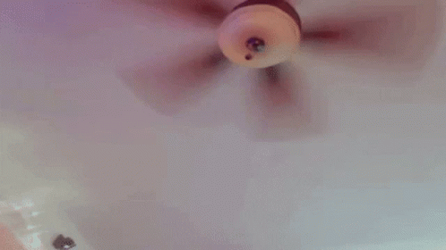 a doll is being held by a person in a bathtub and being played with .