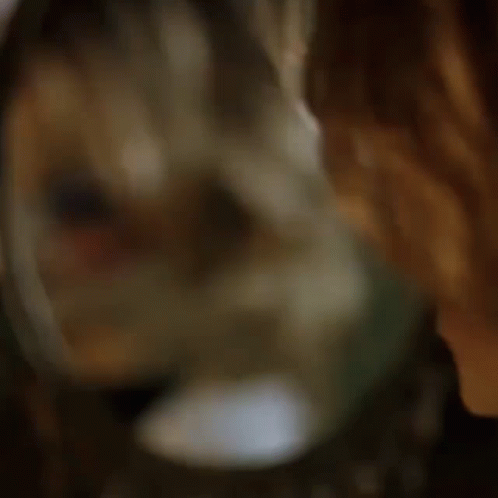 a doll is looking at herself in the mirror