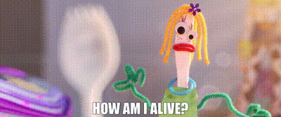 A Doll Made Out Of Pipe Cleaners With The Words `` How Am I Alive '' Written On It GIF