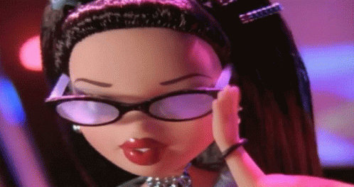 A Doll Wearing Glasses And A Necklace Is Covering Her Ear GIF