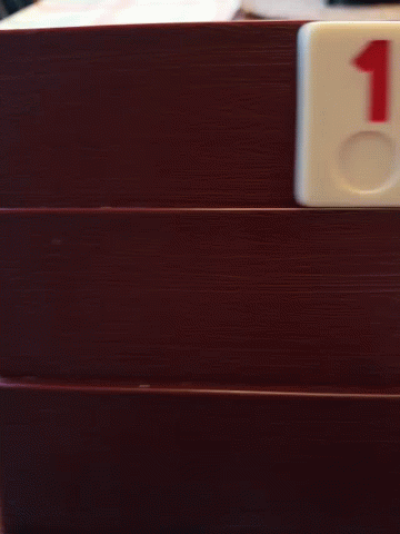 A Domino With The Number 2 On It Is On A Wooden Door GIF