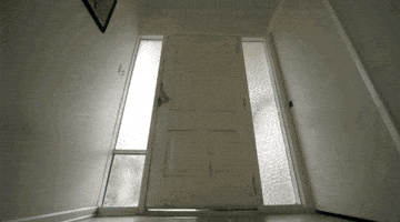 A Door That Is Open And Has A Picture On The Wall Above It GIF