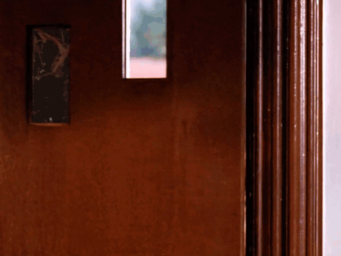 A Door With A Broken Mirror On It GIF