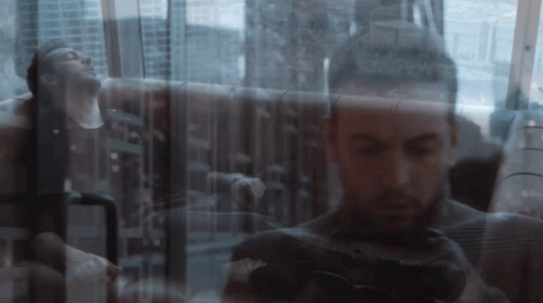 a double exposure of a man taking a picture with a canon camera
