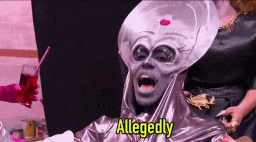 A Drag Queen Dressed As An Alien Is Holding A Drink And A Straw . GIF