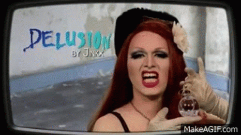 A Drag Queen Is Holding A Bottle Of Perfume In Front Of Her Face And Screaming . GIF