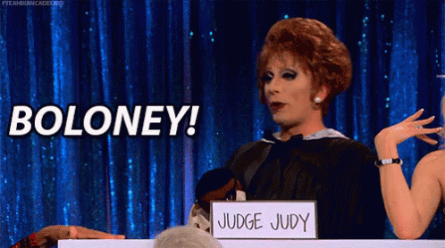 a drag queen is holding a sign that says boloney