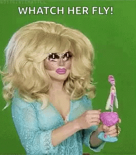 A Drag Queen Is Holding A Toy And Says Whatch Her Fly ! GIF
