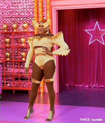 Drag Queen Standing On Stage In Front Of Star GIF
