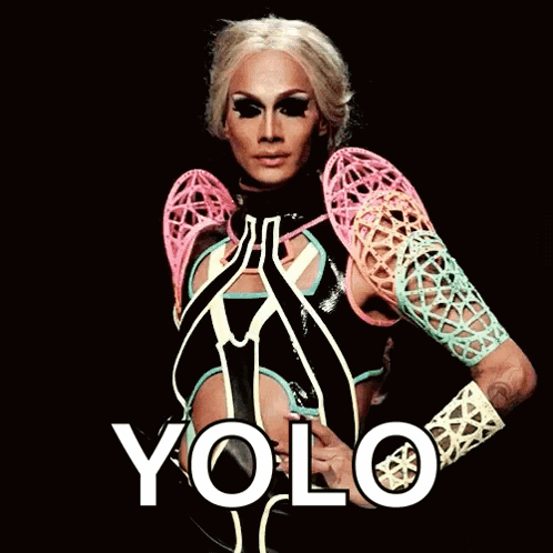 A Drag Queen Is Wearing A Colorful Outfit And The Word Yolo Is On The Bottom Right GIF