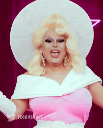 Drag Queen Wearing White Hat And Pink Dress GIF