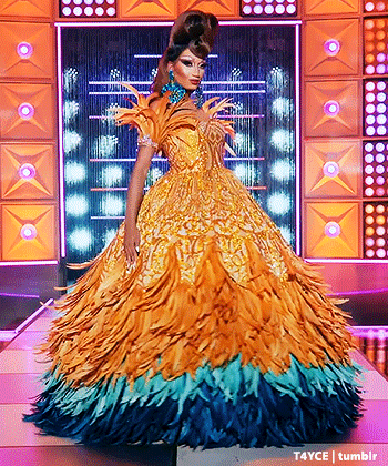 Drag Queen In Yellow And Blue Feathered Dress GIF