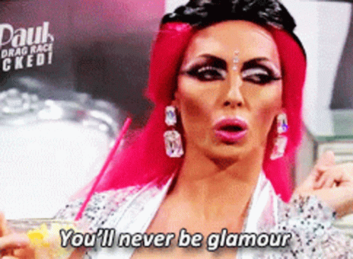 A Drag Queen Says " You 'Ll Never Be Glamour " While Holding A Drink GIF