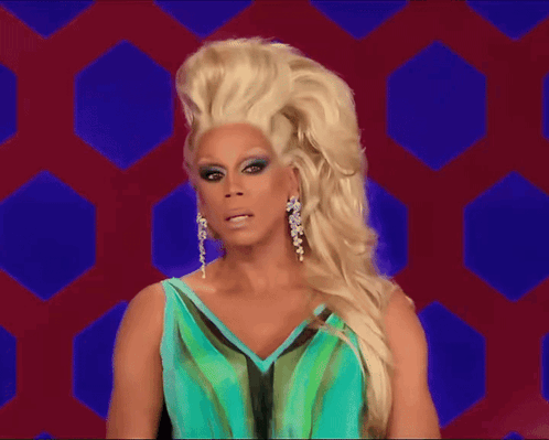 A Drag Queen Wearing A Blue And Green Dress GIF