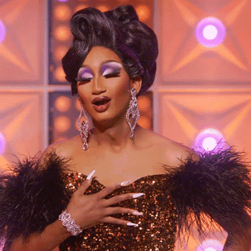 Drag Queen In Feathered Dress And Earrings GIF