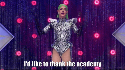 A Drag Queen With Green Hair Says I 'D Like To Thank The Academy On Stage GIF