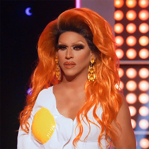 Drag Queen With Orange Hair And Earrings GIF