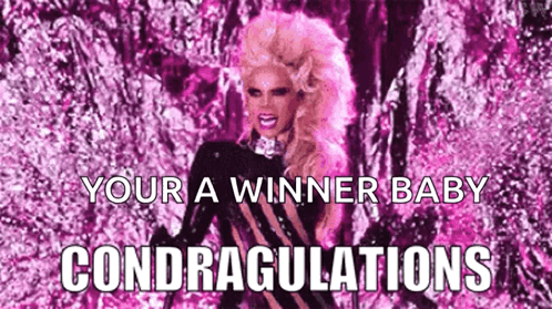 A Drag Queen With Pink Hair Is Standing In Front Of A Pink Background With The Words `` Your A Winner Baby Congratulatio GIF