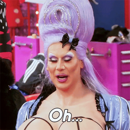 Drag Queen With Purple Hair And Crown Says Oh GIF