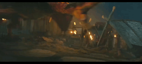 A Dragon Is Flying In The Dark With Flames Behind It GIF