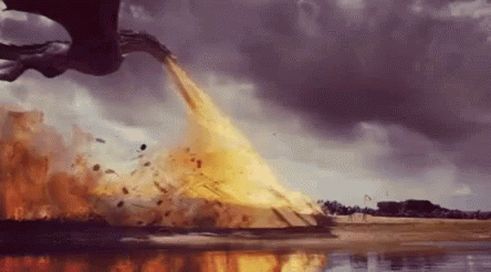 A Dragon Is Flying Over A Body Of Water And Throwing Fire Into The Air . GIF