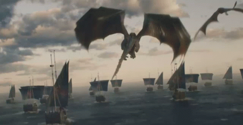 A Dragon Is Flying Over A Body Of Water GIF