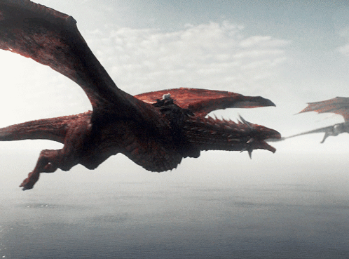 A Dragon Is Flying Over A Body Of Water With Its Wings Outstretched GIF