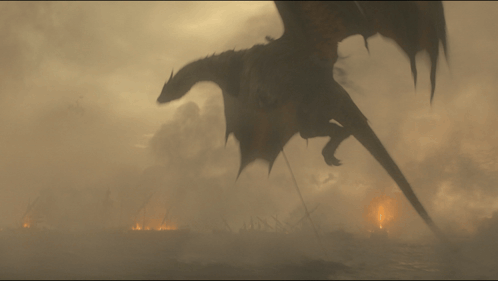 A Dragon Is Flying Over A Burning City In The Fog GIF